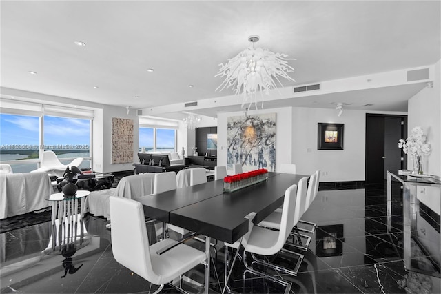 1425 Brickell Ave Unit 42E, Miami, FL 33131 - dining space with granite tiled floors, recessed lighting, a chandelier, and a water view