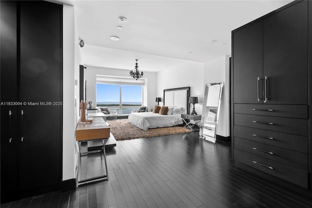 1425 Brickell Ave Unit 42E, Miami, FL 33131 - bedroom featuring a water view, a chandelier, and dark wood-style floors