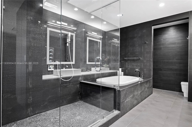 1425 Brickell Ave Unit 42E, Miami, FL 33131 - full bath featuring a bath, a shower stall, recessed lighting, and tile patterned flooring