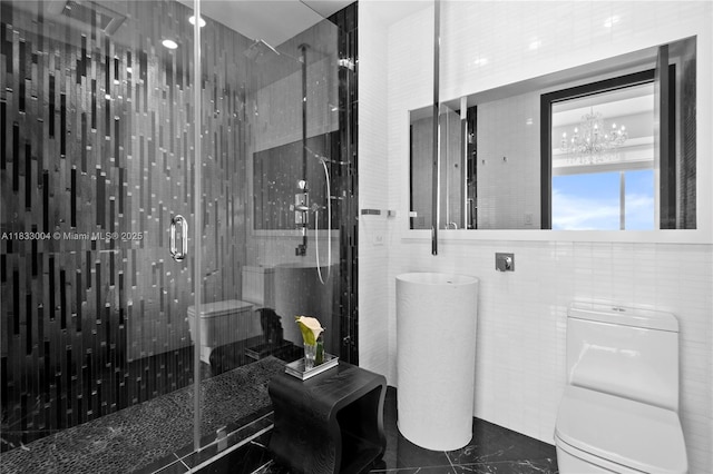 1425 Brickell Ave Unit 42E, Miami, FL 33131 - bathroom featuring a shower stall, marble finish flooring, a chandelier, and tile walls