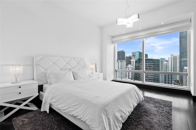 1425 Brickell Ave Unit 42E, Miami, FL 33131 - bedroom with hardwood / wood-style floors and a view of skyline