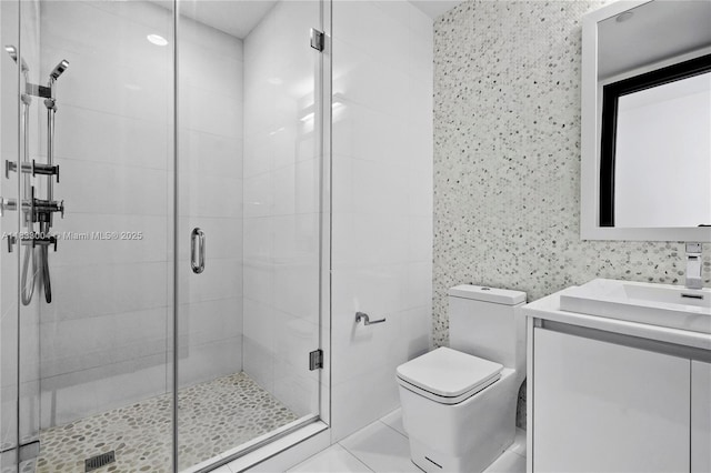 1425 Brickell Ave Unit 42E, Miami, FL 33131 - full bathroom with vanity, a stall shower, and tile walls