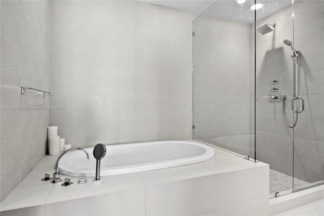 1425 Brickell Ave Unit 42E, Miami, FL 33131 - bathroom featuring a garden tub and a shower stall