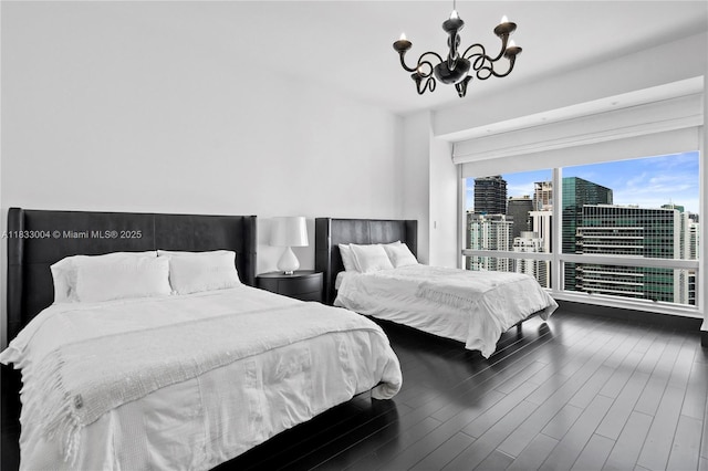 1425 Brickell Ave Unit 42E, Miami, FL 33131 - bedroom with a chandelier, wood finished floors, and a city view