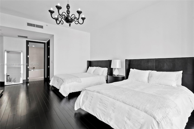 1425 Brickell Ave Unit 42E, Miami, FL 33131 - bedroom with a chandelier and dark wood finished floors