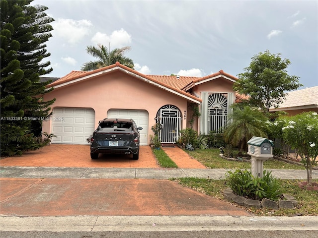 5450 SW 143rd Ct, Miami, FL 33175 - mediterranean / spanish home featuring a garage, stucco siding, driveway, and a tiled roof