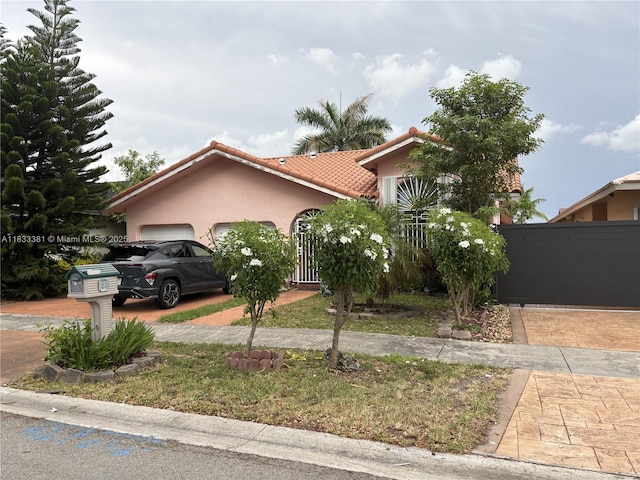 5450 SW 143rd Ct, Miami, FL 33175 - view of front of property featuring an attached garage, stucco siding, and a tiled roof