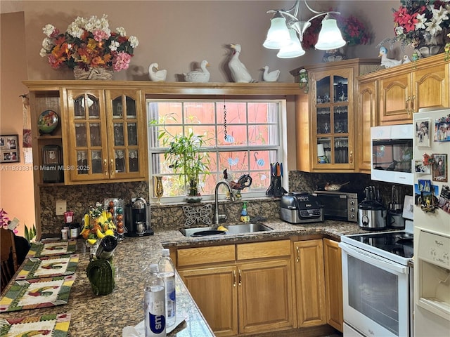 5450 SW 143rd Ct, Miami, FL 33175 - kitchen featuring white appliances, a chandelier, tasteful backsplash, glass insert cabinets, and brown cabinets