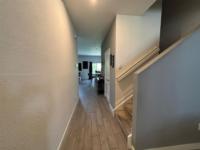 830 SE 19th St, Homestead, FL 33034 - hallway featuring wood finished floors, a textured wall, and stairs