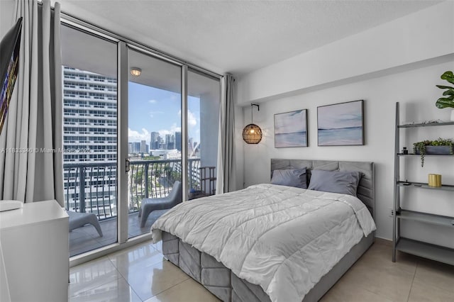 1750 N Bayshore Dr Unit 1204, Miami, FL 33132 - bedroom with a view of city, light tile patterned floors, multiple windows, and a wall of windows
