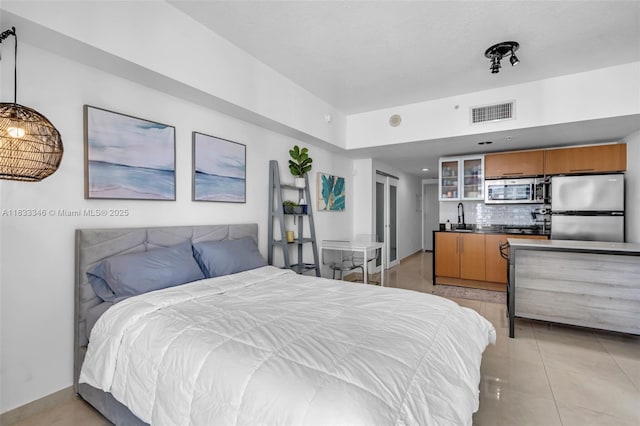 1750 N Bayshore Dr Unit 1204, Miami, FL 33132 - bedroom with freestanding refrigerator and light tile patterned flooring