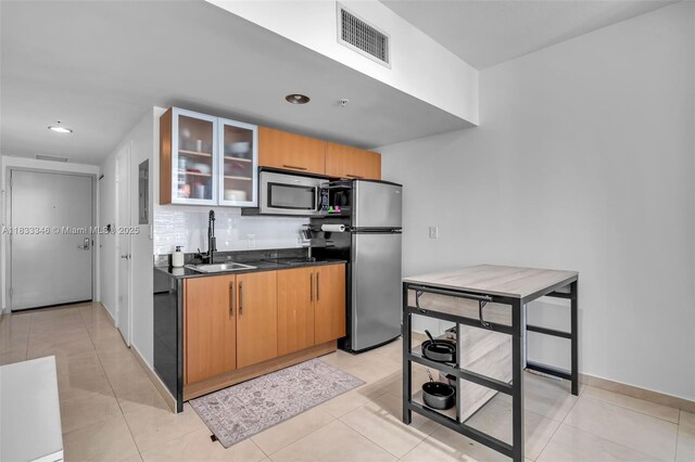 1750 N Bayshore Dr Unit 1204, Miami, FL 33132 - kitchen with stainless steel appliances, dark countertops, glass insert cabinets, recessed lighting, and light tile patterned floors