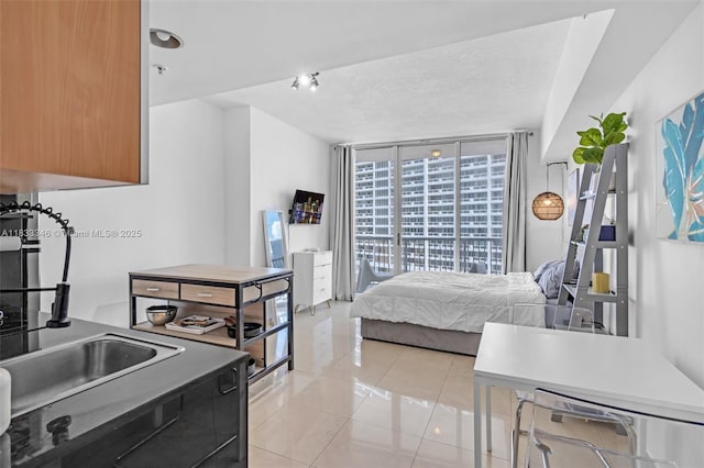 1750 N Bayshore Dr Unit 1204, Miami, FL 33132 - bedroom featuring a wall of windows and light tile patterned flooring