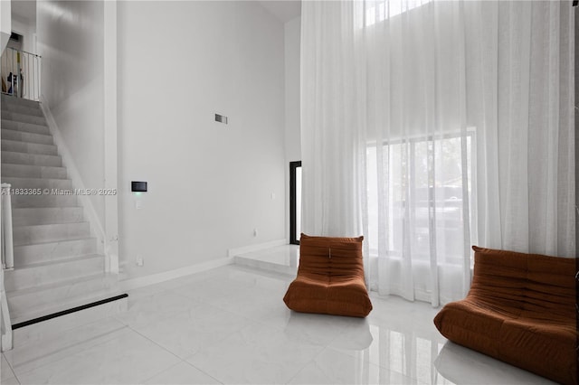 18082 SW 152nd Ct, Miami, FL 33187 - sitting room featuring a high ceiling, stairway, and tile patterned floors