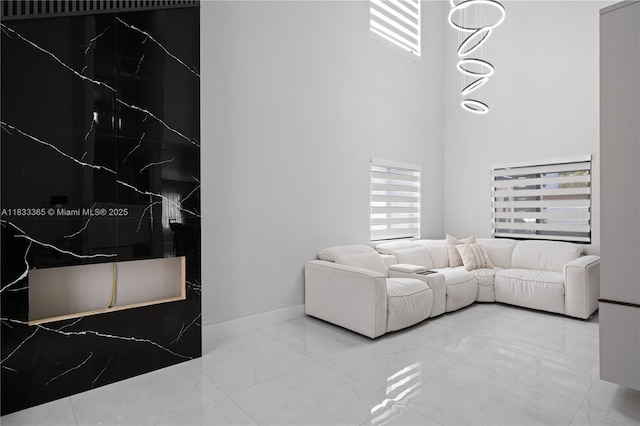 18082 SW 152nd Ct, Miami, FL 33187 - living area with healthy amount of natural light, marble finish flooring, and a high ceiling