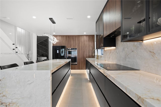 18082 SW 152nd Ct, Miami, FL 33187 - kitchen with modern cabinets, black appliances, recessed lighting, under cabinet range hood, and light stone countertops