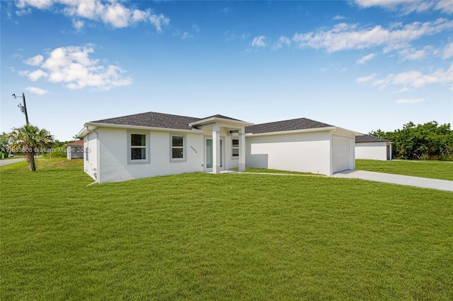 2506 5th St SW, Lehigh Acres, FL 33976 - prairie-style house with a front lawn, concrete driveway, and stucco siding