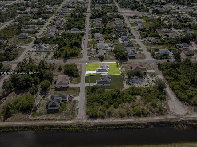 2506 5th St SW, Lehigh Acres, FL 33976 - aerial view of property and surrounding area with nearby suburban area and a large body of water