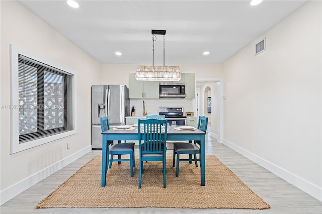 742 NW 70th St, Miami, FL 33150 - dining area with light wood finished floors, arched walkways, plenty of natural light, and recessed lighting