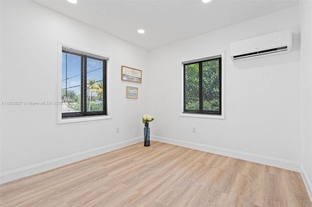 742 NW 70th St, Miami, FL 33150 - empty room with a wall mounted AC, healthy amount of natural light, light wood-style flooring, and recessed lighting