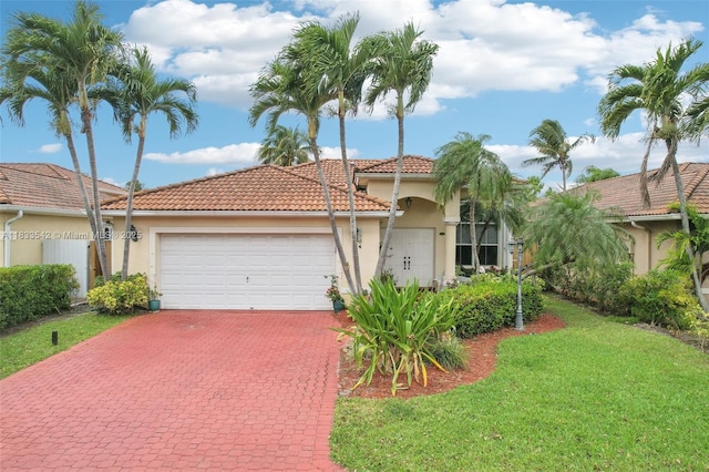 9364 SW 164th Ct, Miami, FL 33196 - mediterranean / spanish-style home with an attached garage, stucco siding, decorative driveway, and a tiled roof