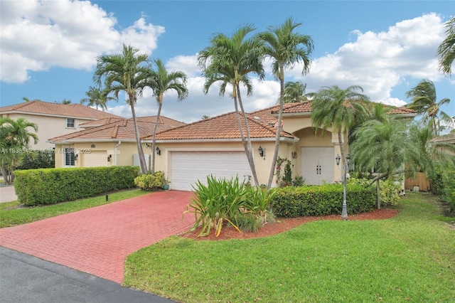 9364 SW 164th Ct, Miami, FL 33196 - mediterranean / spanish-style house with stucco siding, a garage, a front lawn, decorative driveway, and a tiled roof