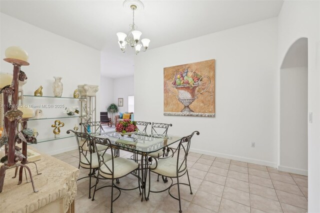 9364 SW 164th Ct, Miami, FL 33196 - tiled dining space with arched walkways and a chandelier