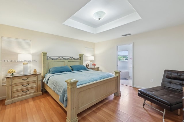 9364 SW 164th Ct, Miami, FL 33196 - bedroom with light wood-style floors, a raised ceiling, and ensuite bathroom