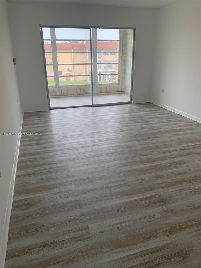8861 Sunrise Lakes Blvd Unit 307, Sunrise, FL 33322 - unfurnished room featuring wood finished floors and baseboards