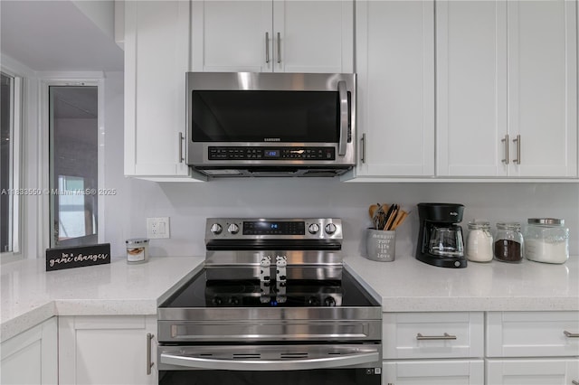 4326 Jackson St, Hollywood, FL 33021 - kitchen featuring stainless steel appliances, white cabinets, and light countertops