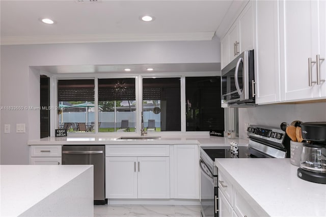 4326 Jackson St, Hollywood, FL 33021 - kitchen featuring appliances with stainless steel finishes, crown molding, light countertops, light marble finish floors, and white cabinetry