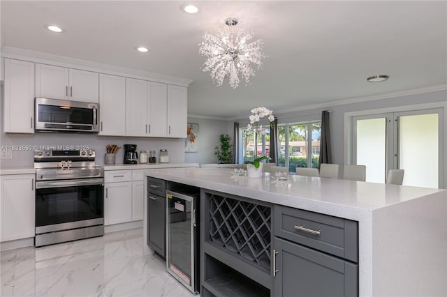 4326 Jackson St, Hollywood, FL 33021 - kitchen featuring appliances with stainless steel finishes, wine cooler, recessed lighting, a chandelier, and ornamental molding