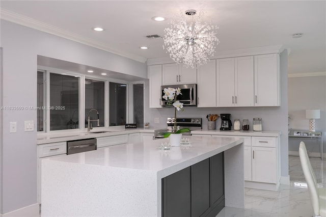 4326 Jackson St, Hollywood, FL 33021 - kitchen featuring appliances with stainless steel finishes, crown molding, light countertops, light marble finish flooring, and white cabinetry