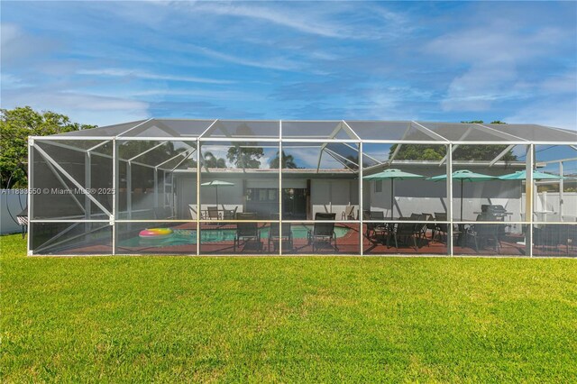4326 Jackson St, Hollywood, FL 33021 - rear view of house featuring a patio, an outdoor pool, a lawn, and glass enclosure