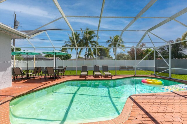 4326 Jackson St, Hollywood, FL 33021 - view of swimming pool featuring a fenced backyard, a patio area, and glass enclosure