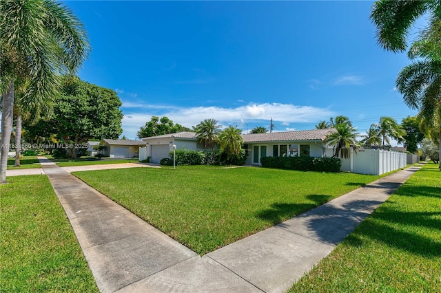 4326 Jackson St, Hollywood, FL 33021 - single story home with an attached garage, concrete driveway, a front lawn, a tile roof, and stucco siding