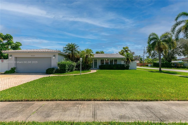 4326 Jackson St, Hollywood, FL 33021 - single story home with a front yard, driveway, an attached garage, and a tile roof