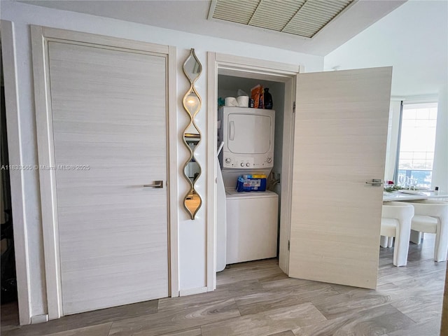 801 S Miami Ave Unit 4204, Miami, FL 33130 - washroom with estacked washer and dryer and wood finished floors