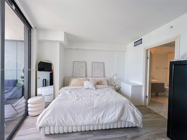 801 S Miami Ave Unit 4204, Miami, FL 33130 - bedroom with access to exterior, wood finished floors, and ensuite bath