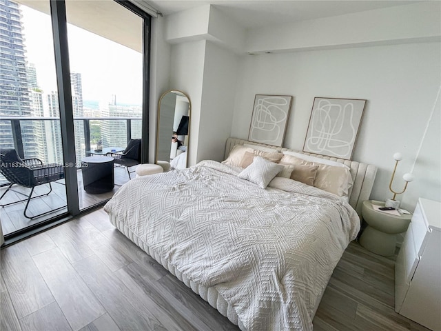 801 S Miami Ave Unit 4204, Miami, FL 33130 - bedroom with wood finished floors, expansive windows, and a view of city