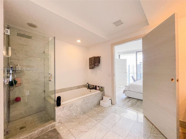 801 S Miami Ave Unit 4204, Miami, FL 33130 - ensuite bathroom with a bath, a shower stall, marble look tiles, and recessed lighting