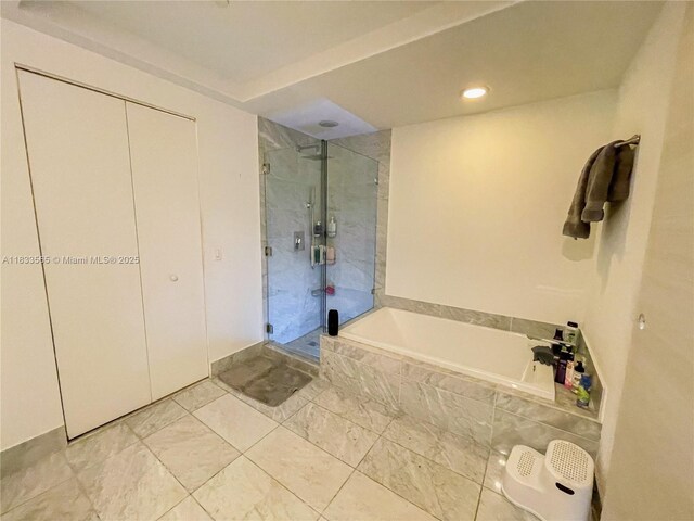 801 S Miami Ave Unit 4204, Miami, FL 33130 - full bathroom with a stall shower, a garden tub, and recessed lighting