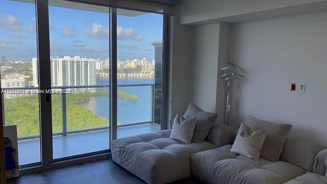 16385 Biscayne Blvd Unit 2702, North Miami Beach, FL 33160 - living room with healthy amount of natural light, a wall of windows, a water view, and a view of city