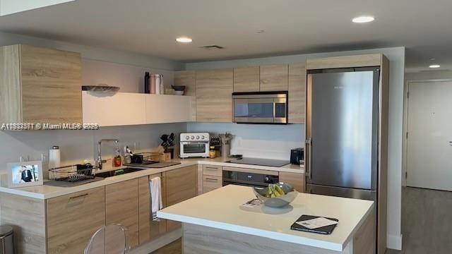 16385 Biscayne Blvd Unit 2702, North Miami Beach, FL 33160 - kitchen featuring stainless steel appliances, modern cabinets, light countertops, recessed lighting, and light brown cabinetry