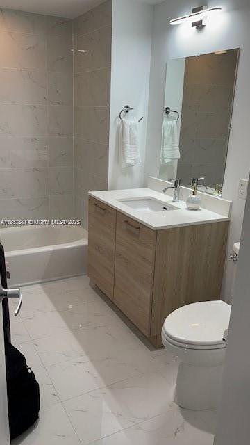 16385 Biscayne Blvd Unit 2702, North Miami Beach, FL 33160 - full bathroom with vanity, marble finish floors, and shower / bath combination
