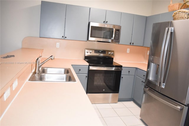 9123 SW 152nd Path, Miami, FL 33196 - kitchen with appliances with stainless steel finishes, gray cabinetry, light tile patterned floors, and light countertops
