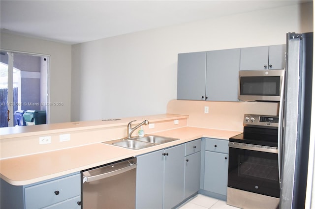 9123 SW 152nd Path, Miami, FL 33196 - kitchen with stainless steel appliances, a peninsula, light countertops, and light tile patterned floors