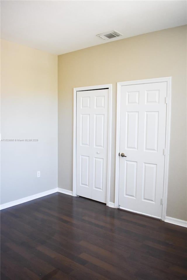 9123 SW 152nd Path, Miami, FL 33196 - unfurnished bedroom with dark wood-type flooring and a closet