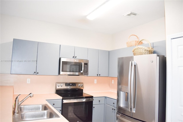 9123 SW 152nd Path, Miami, FL 33196 - kitchen featuring appliances with stainless steel finishes, gray cabinets, and light countertops