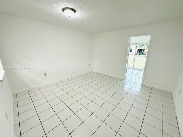 505 NW 177th St Unit 139, Miami Gardens, FL 33169 - spare room with a textured ceiling and light tile patterned flooring